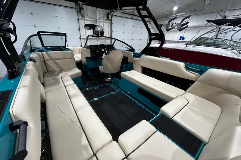 Slide: The Image of 2026 Moomba Tykon boat interior with beige seating and modern dashboard design. - 7