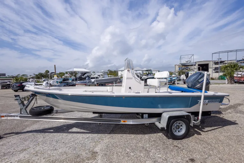 Slide: The Image of 2007 Pathfinder 2000 V boat on trailer, parked outdoors under a cloudy sky. - 13