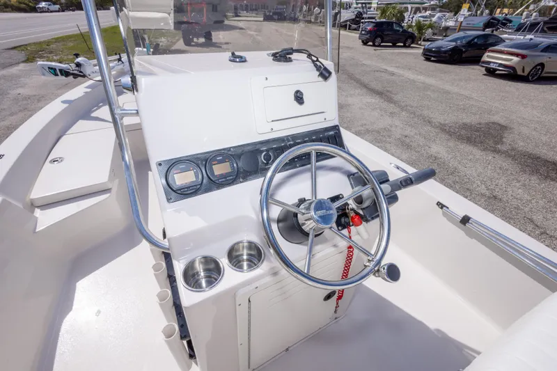 Slide: The Image of Steering console of a 2007 Pathfinder 2000 V boat, featuring gauges and cup holders. - 17