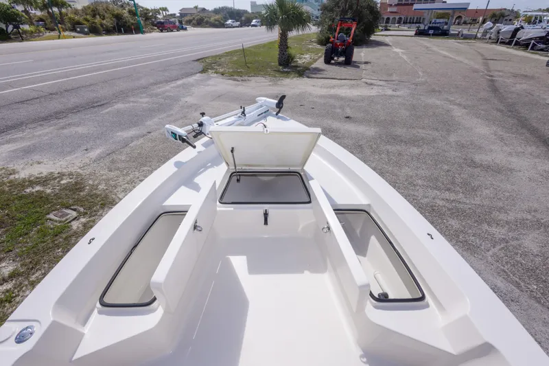 Slide: The Image of 2007 Pathfinder 2000 V boat with open storage compartments, parked near a road. - 19