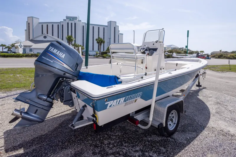 Slide: The Image of 2007 Pathfinder 2000 V boat with Yamaha engine on trailer, parked near a hotel. - 2
