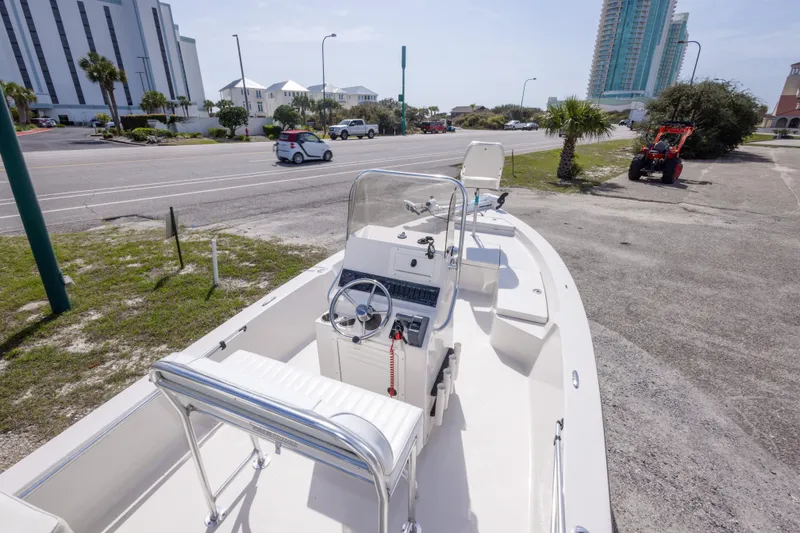 Slide: The Image of 2007 Pathfinder 2000 V boat parked near a road with buildings in the background. - 21