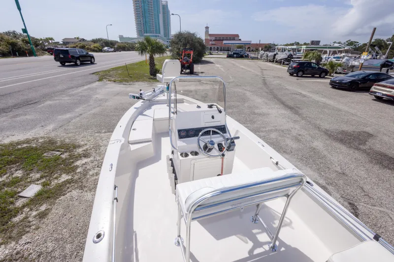 Slide: The Image of 2007 Pathfinder 2000 V boat parked near a road with buildings in the background. - 22