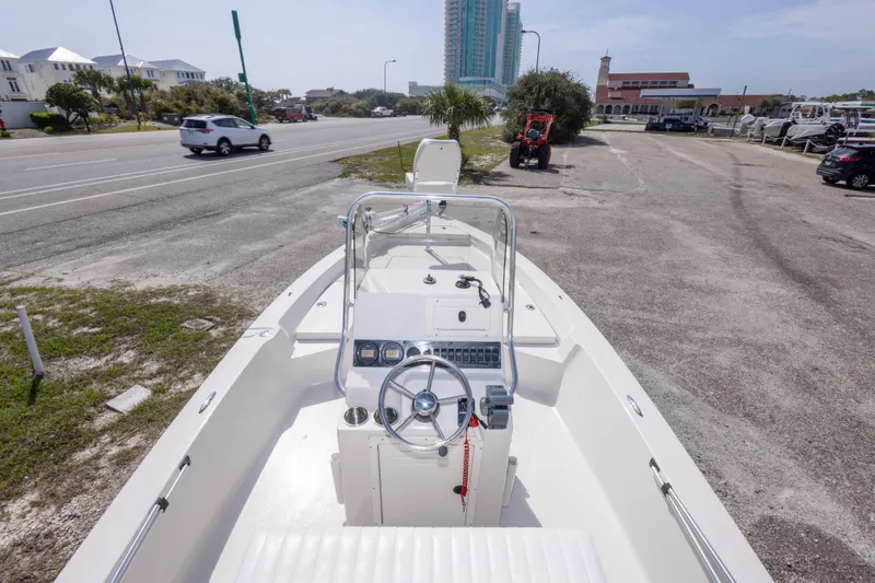 Slide: The Image of 2007 Pathfinder 2000 V boat parked near a road with buildings in the background. - 23