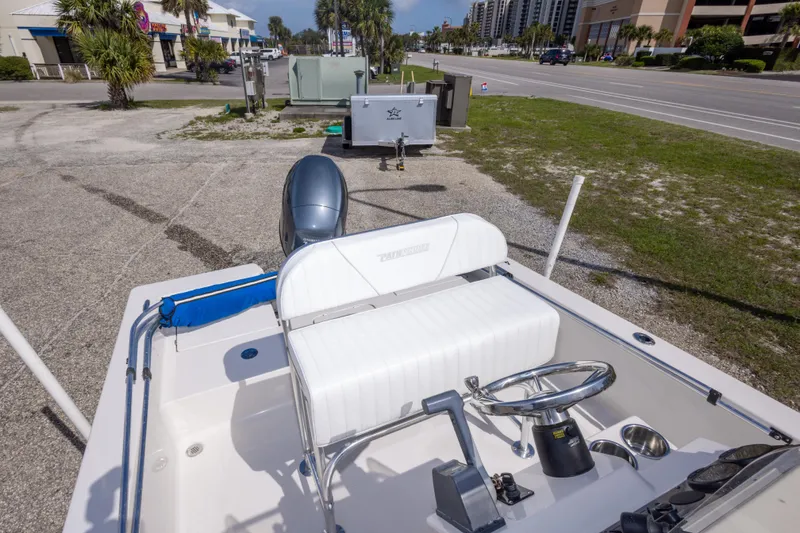 Slide: The Image of 2007 Pathfinder 2000 V boat with steering wheel and seating, parked near a road. - 26