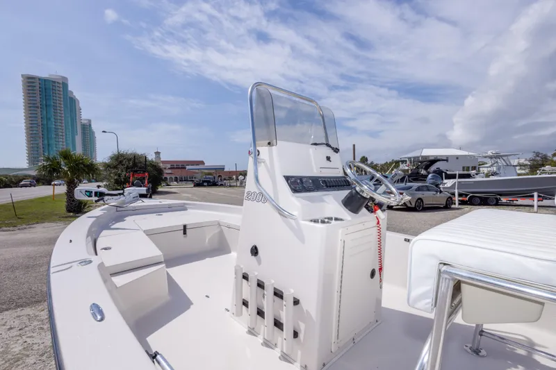 Slide: The Image of 2007 Pathfinder 2000 V boat with steering console, parked near buildings and other boats. - 32