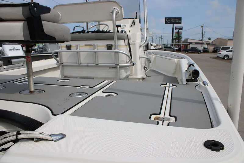 Slide: The Image of 2018 Mako 21 LTS boat interior with seating and storage compartments. - 11