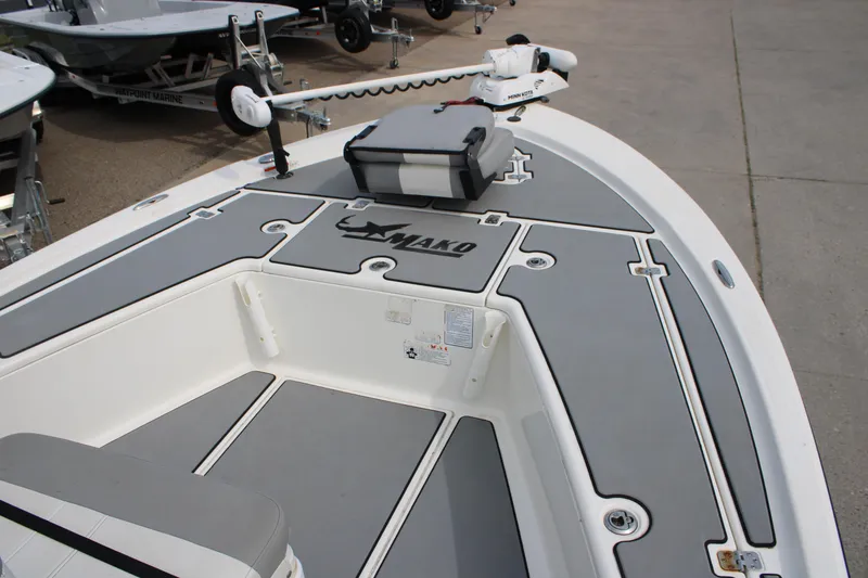 Slide: The Image of 2018 Mako 21 LTS boat deck with storage compartments and trolling motor. - 12