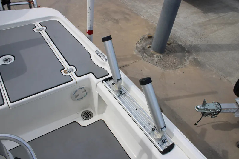 Slide: The Image of 2018 Mako 21 LTS boat deck with rod holders and storage compartments. - 14