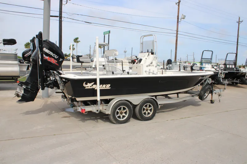 Slide: The Image of 2018 Mako 21 LTS boat on trailer, featuring a Mercury outboard motor. - 19