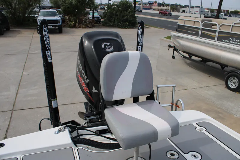 Slide: The Image of 2018 Mako 21 LTS boat with Mercury engine and Power-Pole anchors, parked outdoors. - 6
