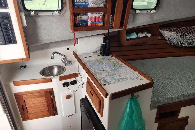 Slide: The Image of Compact boat interior with sink, map, and storage in 2018 Acadia Atlas model. - 10