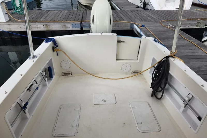 Slide: The Image of 2018 Acadia Atlas boat deck at marina with ropes and storage compartments. - 2