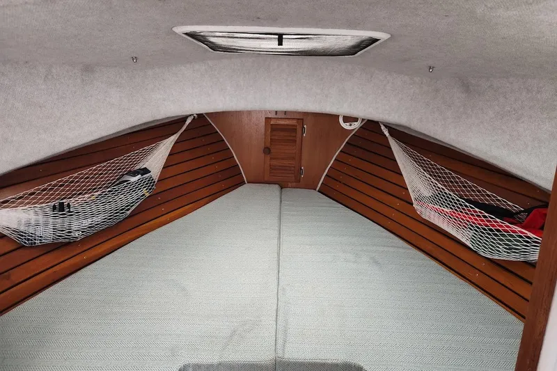 Slide: The Image of Cozy cabin interior of 2018 Acadia Atlas boat with wooden paneling and netted storage. - 9