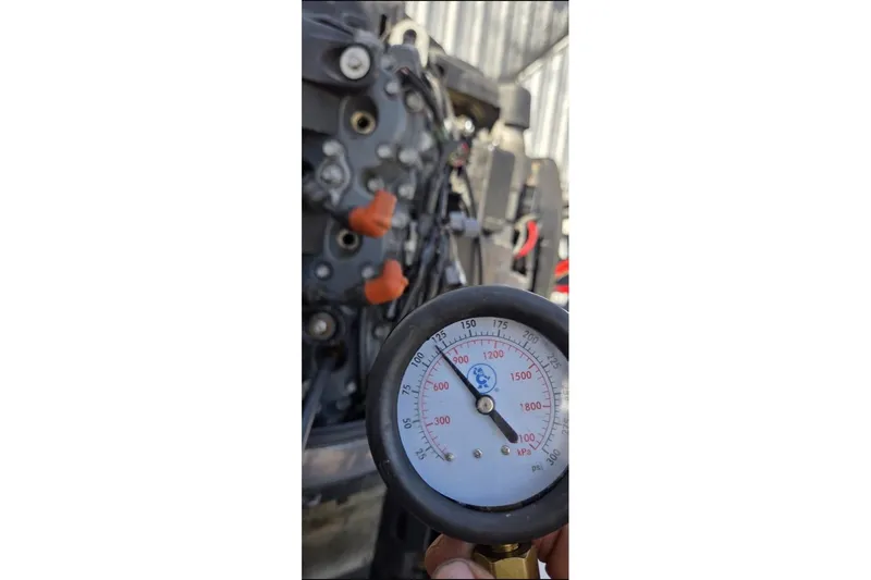 Slide: The Image of Pressure gauge reading near Ranger Z19 Comanche 2006 engine components. - 17