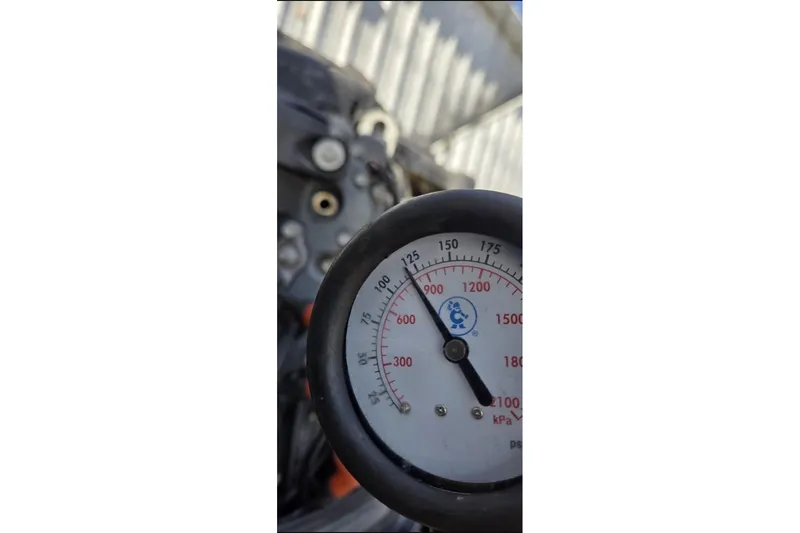 Slide: The Image of Close-up of a pressure gauge on a 2006 Ranger Z19 Comanche boat. - 18