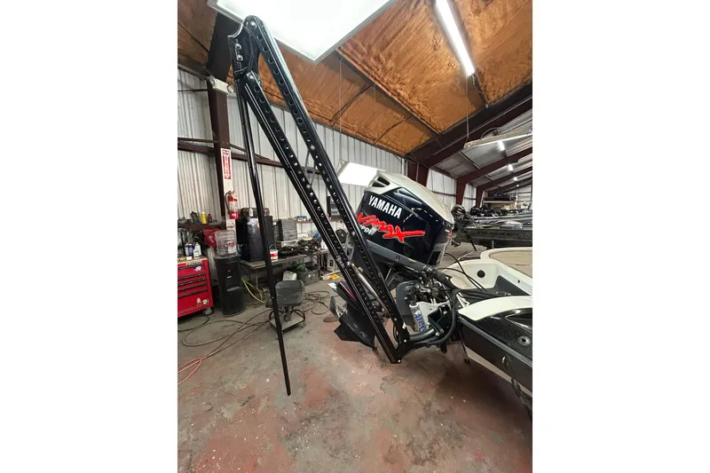 Slide: The Image of 2006 Ranger Z19 Comanche boat with Yamaha motor in a workshop setting. - 21