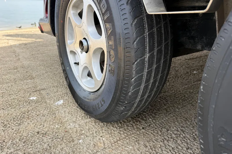 Slide: The Image of Close-up of a 2006 Ranger Z19 Comanche wheel on a textured surface. - 25