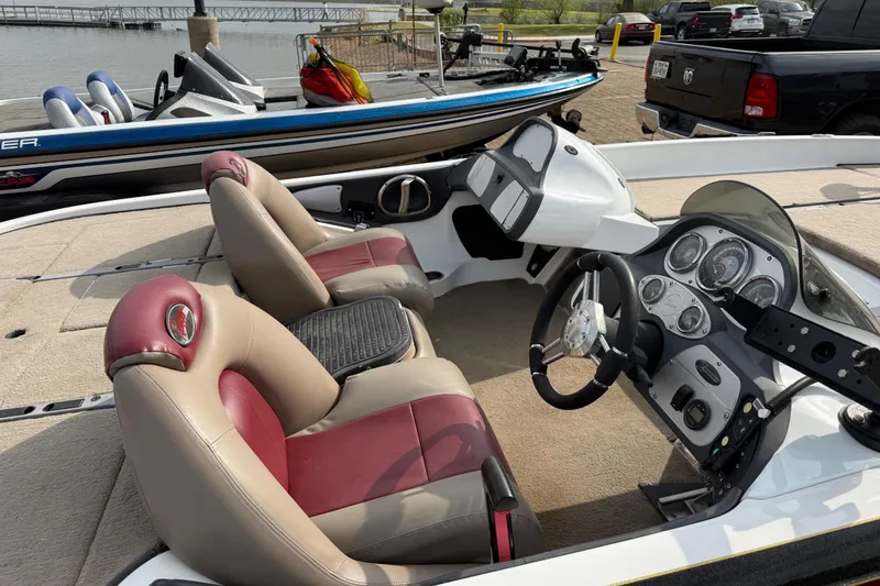 Slide: The Image of 2006 Ranger Z19 Comanche boat interior with dual seats and control panel by the water. - 26