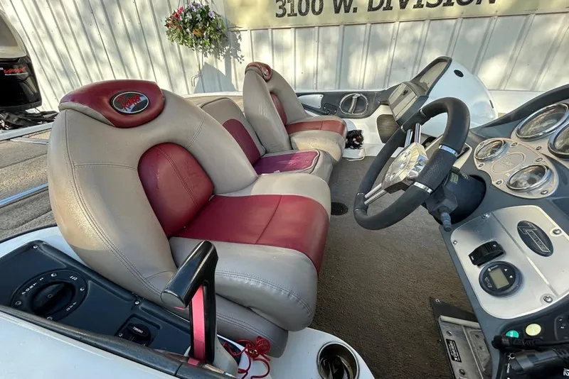 Slide: The Image of 2006 Ranger Z19 Comanche boat interior with red and beige seats, steering wheel, and dashboard. - 5