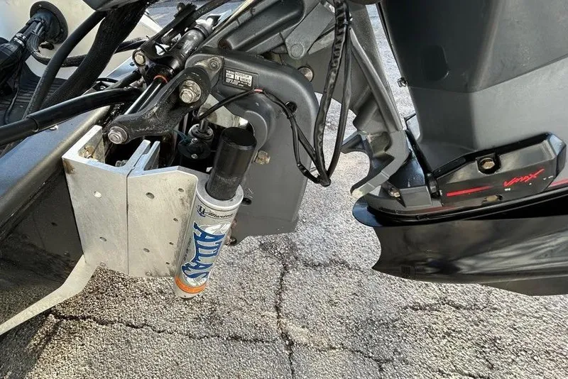 Slide: The Image of Close-up of 2006 Ranger Z19 Comanche boat motor components on pavement. - 6