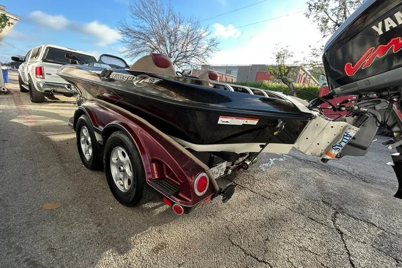 Slide: The Image of 2006 Ranger Z19 Comanche boat on trailer, parked outdoors with Yamaha motor. - 9