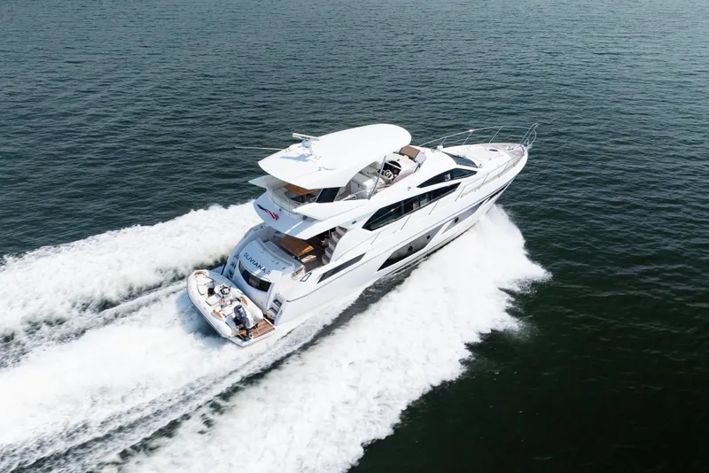 Slide: The Image of 2016 Sunseeker Manhattan 65 yacht cruising on open water. - 2