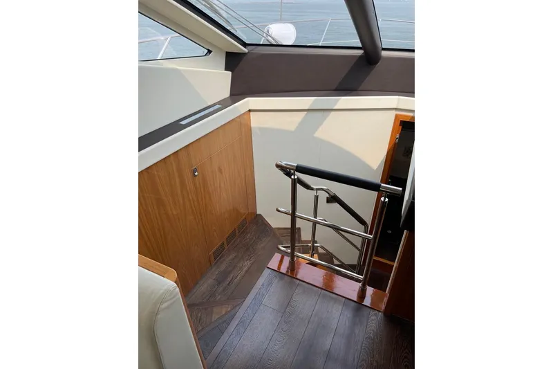 Slide: The Image of Interior staircase of 2016 Sunseeker Manhattan 65 yacht with wooden and metal finishes. - 22