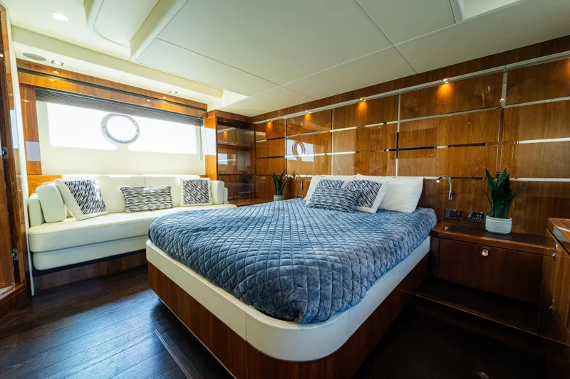 Slide: The Image of Luxurious Sunseeker Manhattan 65 yacht bedroom, 2016 model, featuring elegant wood paneling and plush bedding. - 24