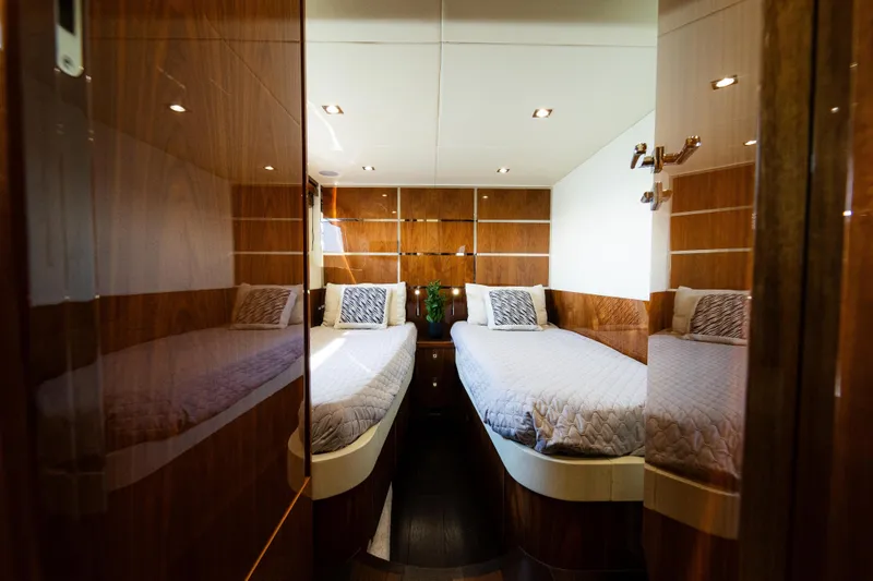 Slide: The Image of Luxurious twin cabin interior of 2016 Sunseeker Manhattan 65 yacht with wood paneling. - 33