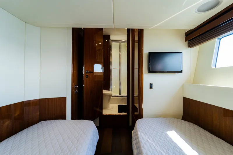Slide: The Image of Luxurious cabin interior of 2016 Sunseeker Manhattan 65 yacht with twin beds and TV. - 34
