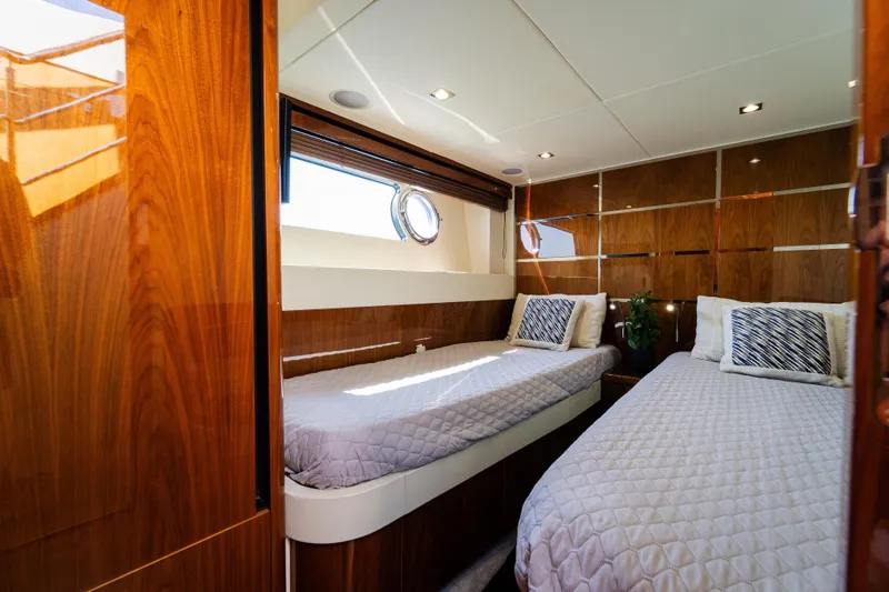 Slide: The Image of Luxurious twin cabin interior of 2016 Sunseeker Manhattan 65 yacht with elegant wood paneling. - 35