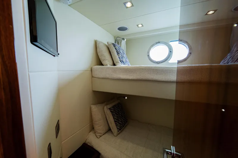 Slide: The Image of Interior of 2016 Sunseeker Manhattan 65 yacht with cozy bunk beds and porthole window. - 37