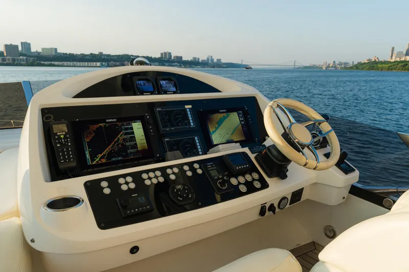 Slide: The Image of Cockpit of 2016 Sunseeker Manhattan 65 yacht with navigation equipment and scenic water view. - 46