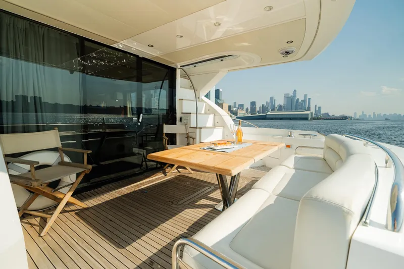 Slide: The Image of Luxurious 2016 Sunseeker Manhattan 65 yacht deck with city skyline view. - 5