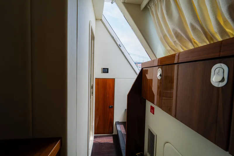 Slide: The Image of Interior hallway of 2016 Sunseeker Manhattan 65 yacht with wooden cabinetry and natural light. - 51