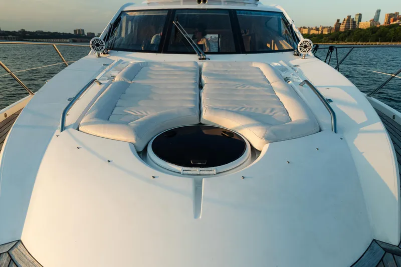 Slide: The Image of 2016 Sunseeker Manhattan 65 yacht with luxurious deck seating, cruising on calm waters. - 53