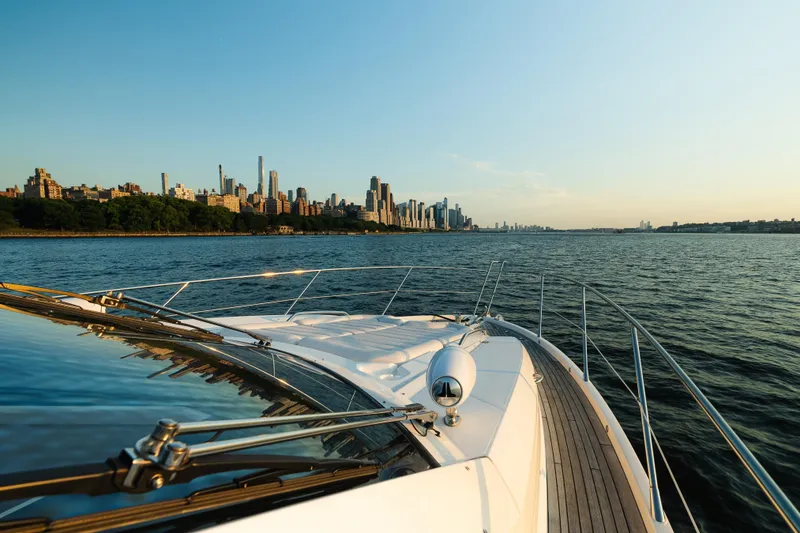 Slide: The Image of Sunseeker Manhattan 65 yacht cruising near city skyline at sunset, 2016 model. - 54