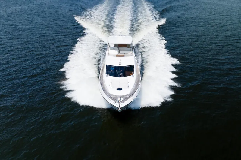 Slide: The Image of 2016 Sunseeker Manhattan 65 yacht cruising on open water, aerial view. - 55