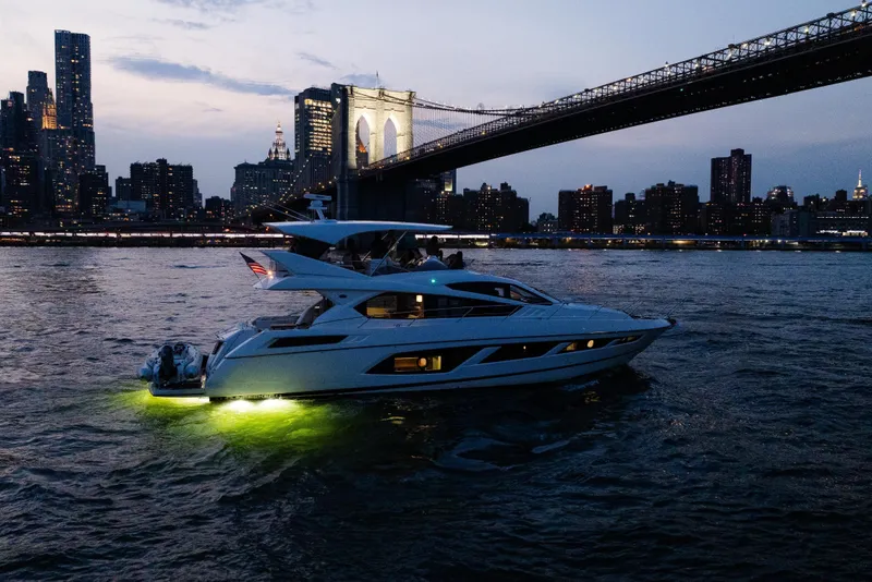 Slide: The Image of Luxurious 2016 Sunseeker Manhattan 65 yacht cruising under Brooklyn Bridge at dusk. - 58