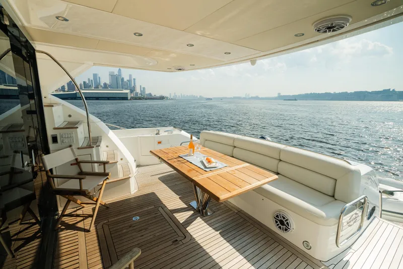 Slide: The Image of Luxurious 2016 Sunseeker Manhattan 65 yacht deck with city skyline view. - 6