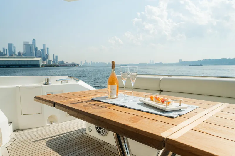 Slide: The Image of Luxurious Sunseeker Manhattan 65 yacht with city skyline, wine, and appetizers on deck. - 8