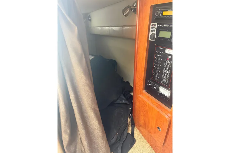 Slide: The Image of 2007 Larson Cabrio 260 cabin interior with control panel and cozy sleeping area. - 11