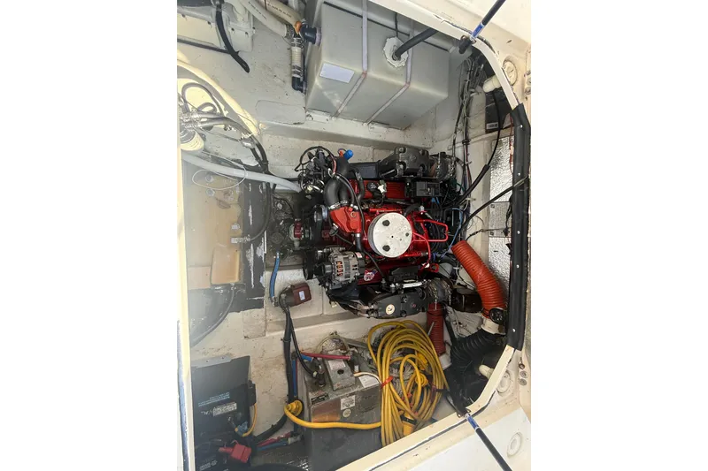 Slide: The Image of Engine compartment of a 2007 Larson Cabrio 260 boat, showcasing mechanical components. - 18