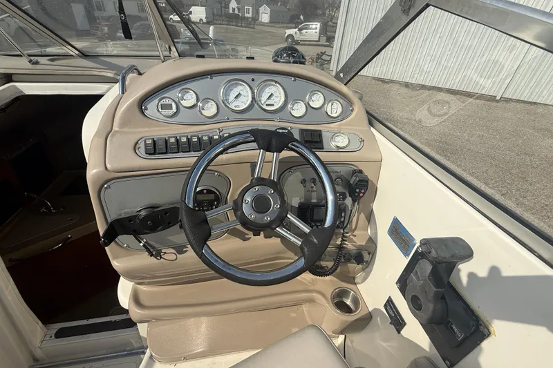 Slide: The Image of 2007 Larson Cabrio 260 boat dashboard with steering wheel and instrument panel. - 19