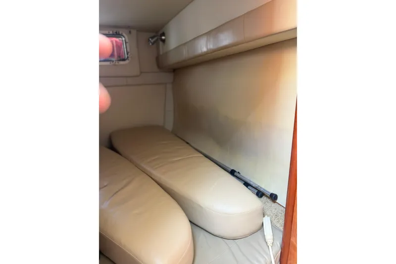 Slide: The Image of 2007 Larson Cabrio 260 cabin interior with beige seating and compact design. - 2