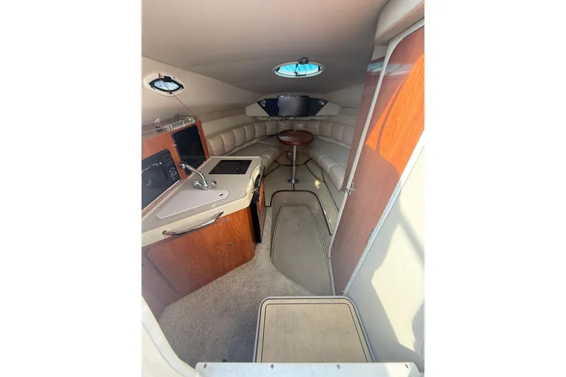 Slide: The Image of Interior of 2007 Larson Cabrio 260 boat with kitchenette and seating area. - 6
