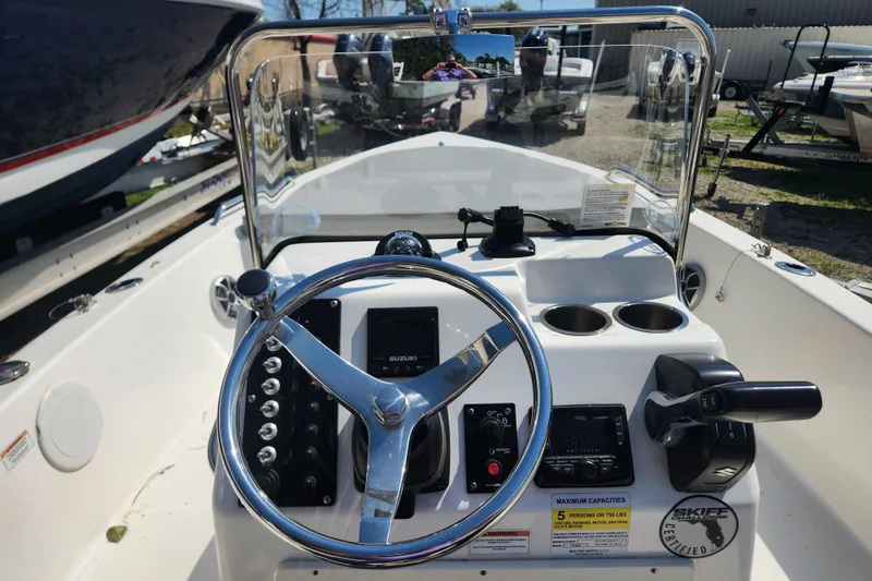 Slide: The Image of 2021 Sea Pro 172 Bay boat dashboard with steering wheel and controls. - 13