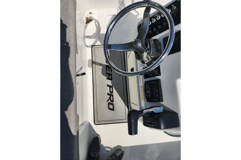 Slide: The Image of 2021 Sea Pro 172 Bay boat dashboard with steering wheel and controls. - 15