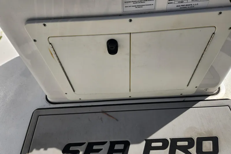 Slide: The Image of 2021 Sea Pro 172 Bay boat storage compartment with visible branding. - 16